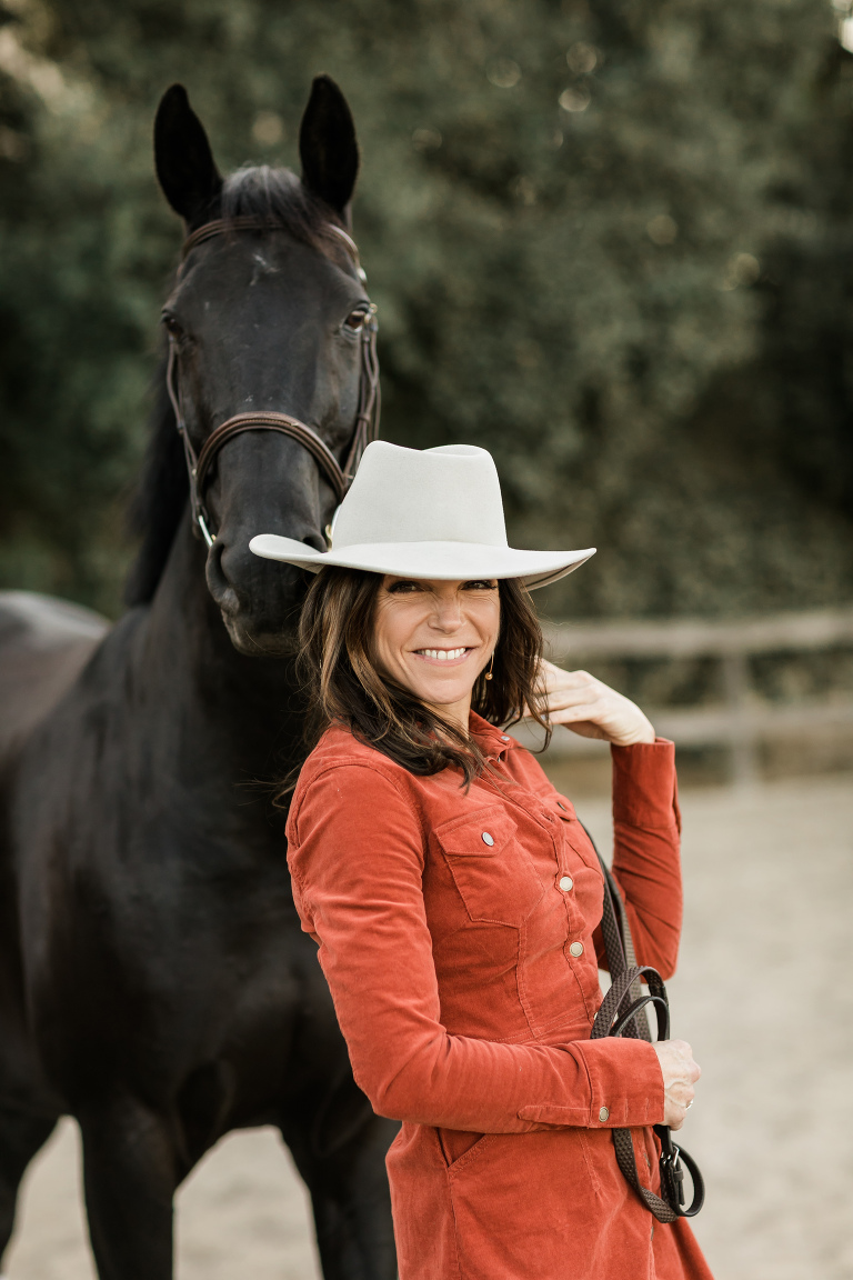 woman smiling with black horse by California Equine Photographer, Elizabeth Hay Photography.
