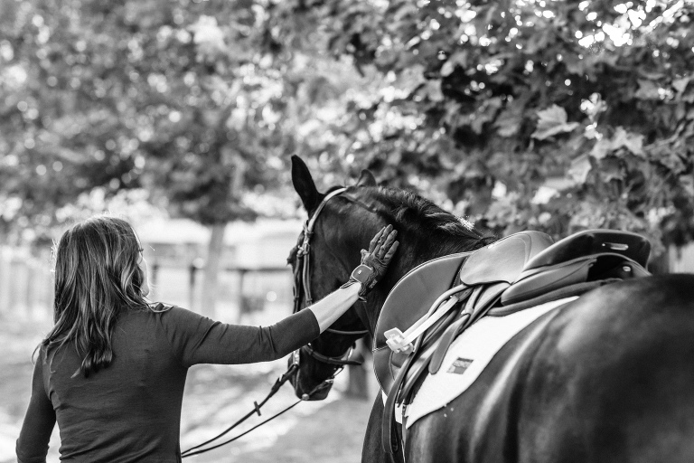 Black and White image of rider petting horse at Amanda Garcia Equestrian session with California Equine Photographer, Elizabeth Hay Photography.