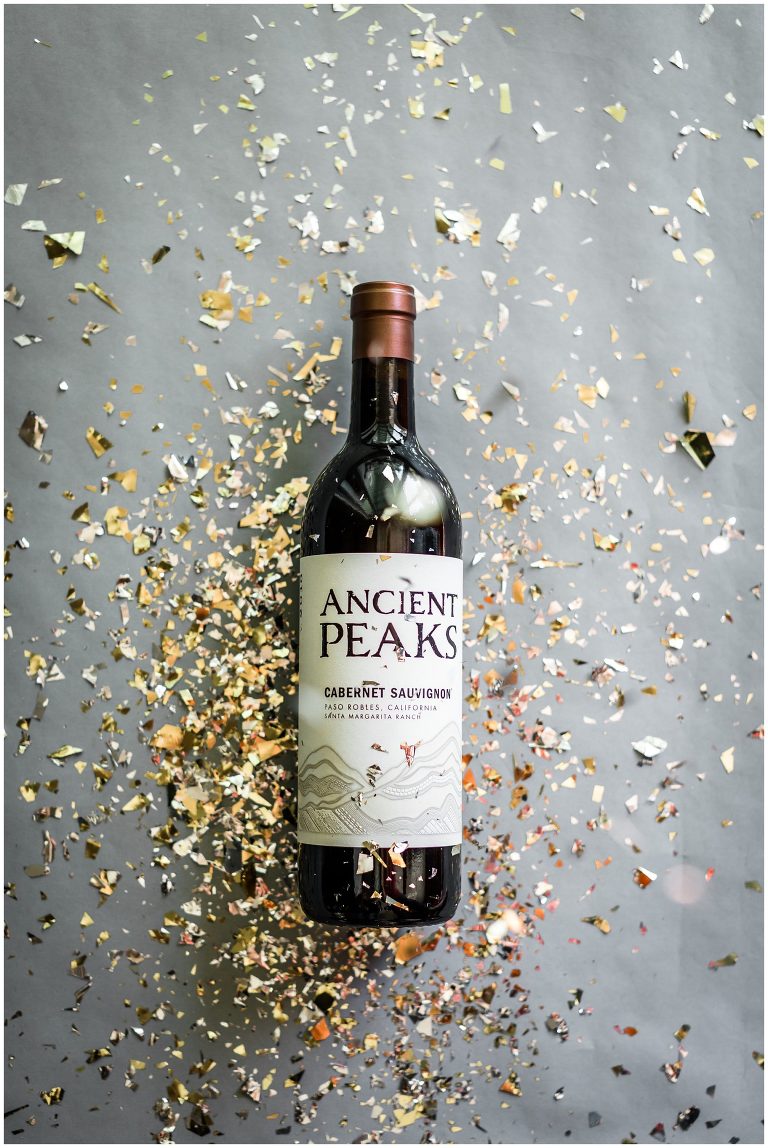 Wine bottle and glitter confetti for holidays by Elizabeth Hay Photography