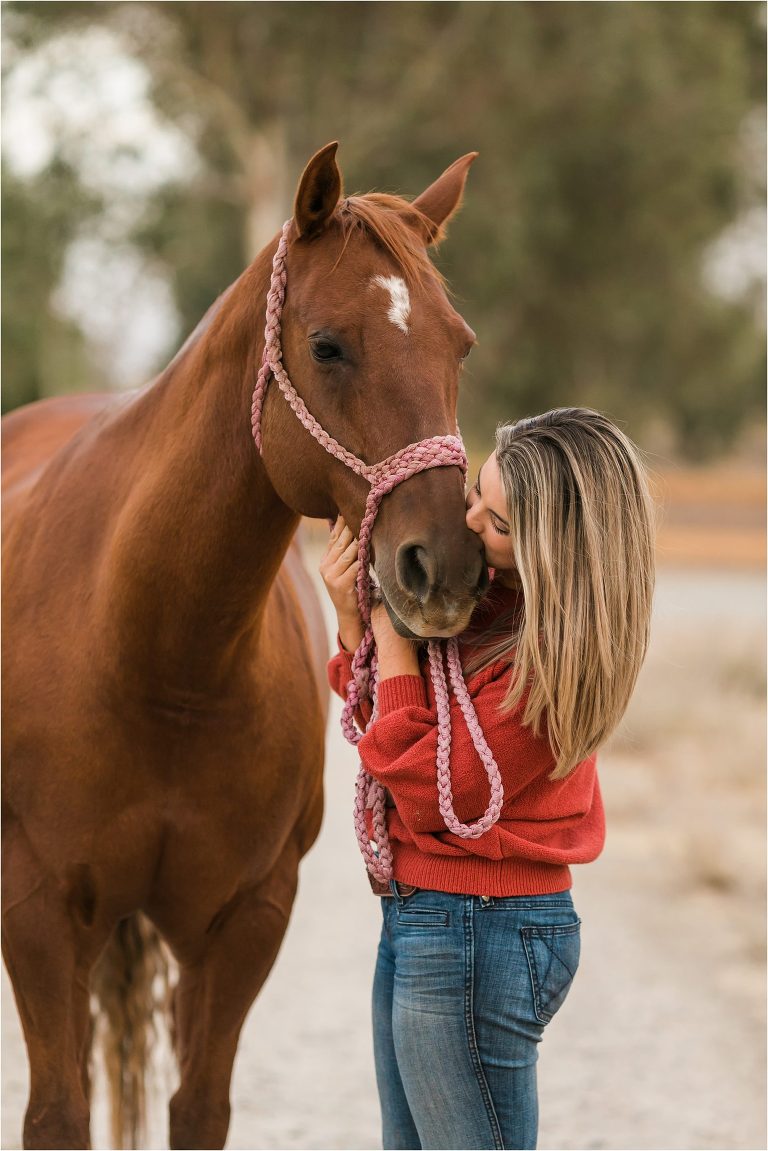 Clovis California Equine Photography session with Ashley kissing her sorrel mare by Elizabeth Hay Photography