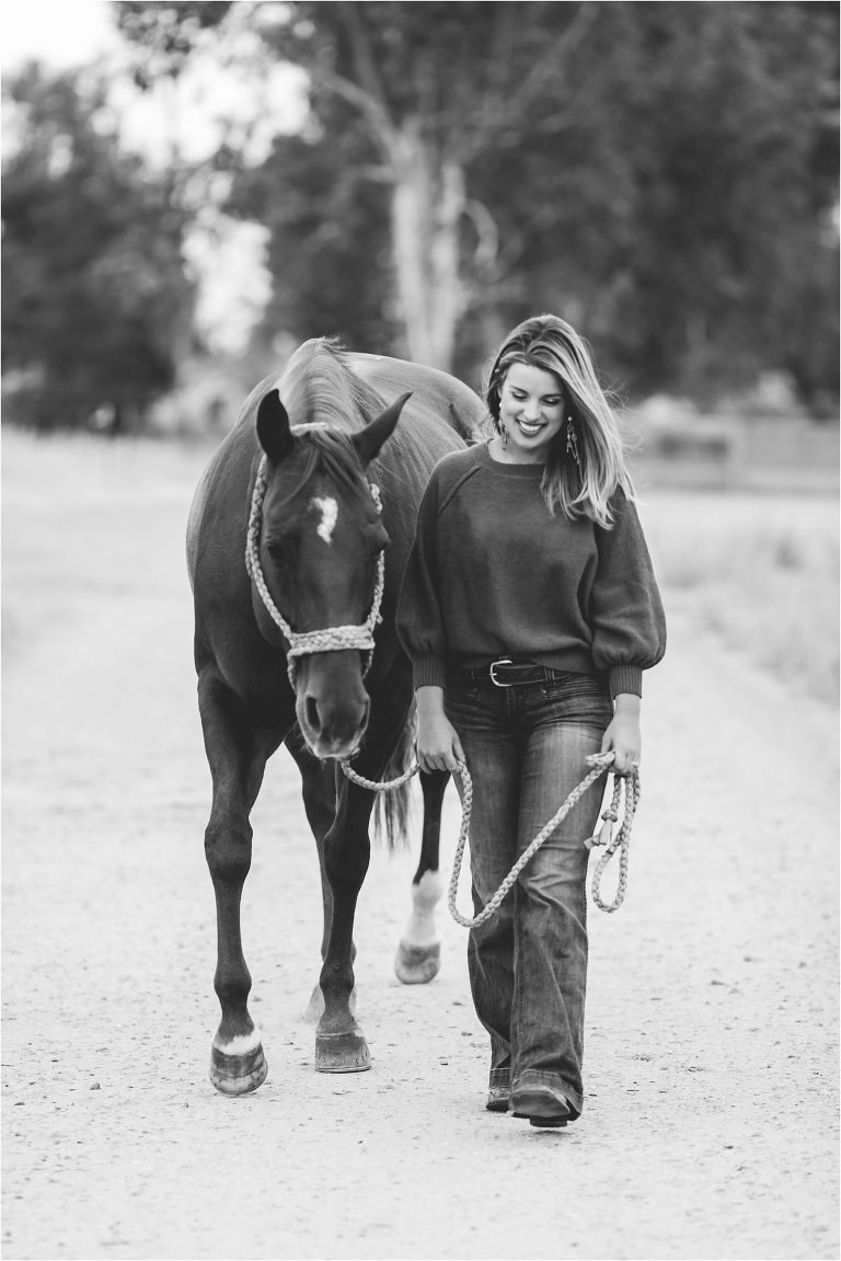 woman walking with horse and smiling by California Equine Photographer Elizabeth Hay Photography
