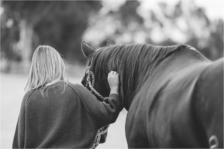 woman walking with horse and petting her by California Equine Photographer Elizabeth Hay Photography
