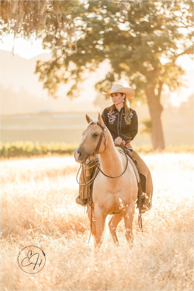 California cowgirl sitting on a palomino horse