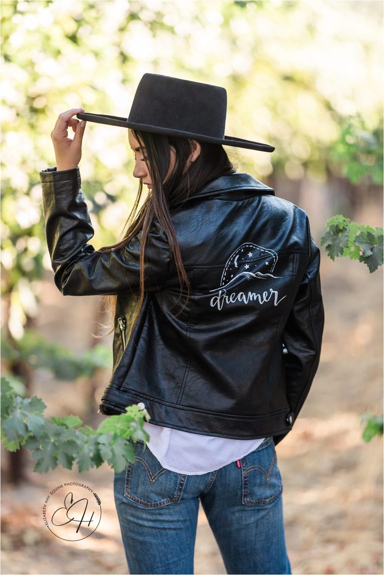 brunette model wearing a leather hand-painted jacket at the 2018 Elizabeth Hay Photography workshop at Oyster Ridge wedding venue in Santa Margarita, California.