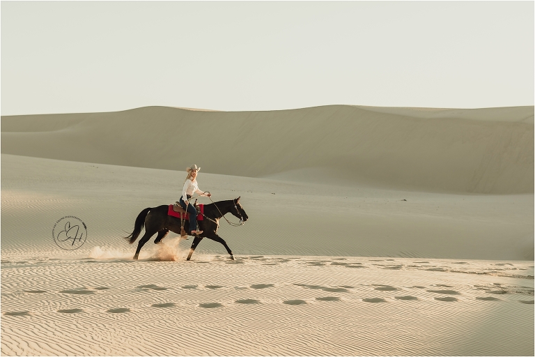 Cowgirl and black horse at the Pismo Beach Dunes by Elizabeth Hay Photography