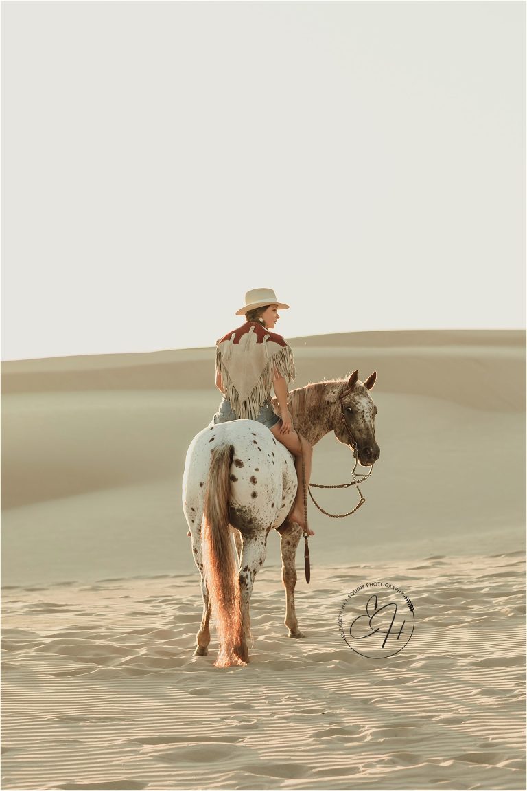 Woman and Appaloosa horse at the Pismo Beach Dunes by Elizabeth Hay Photography
