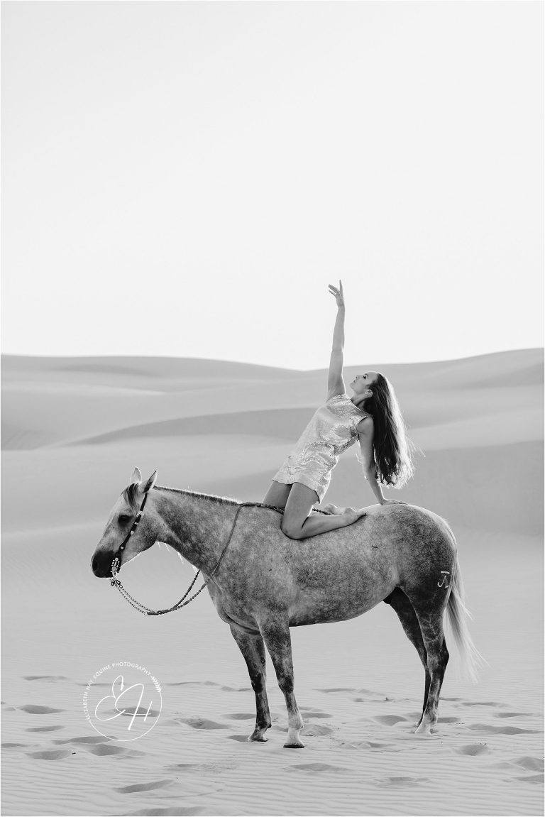 high fashion equine shoot of Woman and grey gelding at the Pismo Beach Dunes by Elizabeth Hay Photography