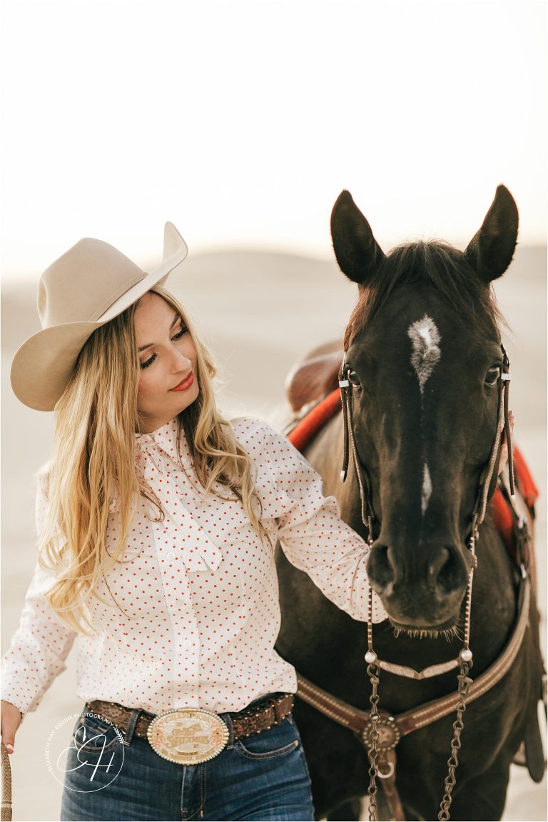 vintage cowgirl with horse at a high fashion equine shoot at the Pismo Beach Dunes by Elizabeth Hay Photography