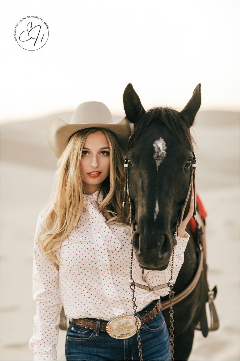 cowgirl with black horse at a high fashion equine shoot at the Pismo Beach Dunes by Elizabeth Hay Photography