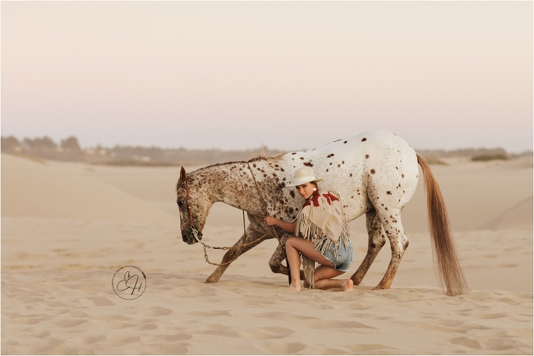 bowing Appaloosa horse at a high fashion equine shoot at the Pismo Beach Dunes by Elizabeth Hay Photography