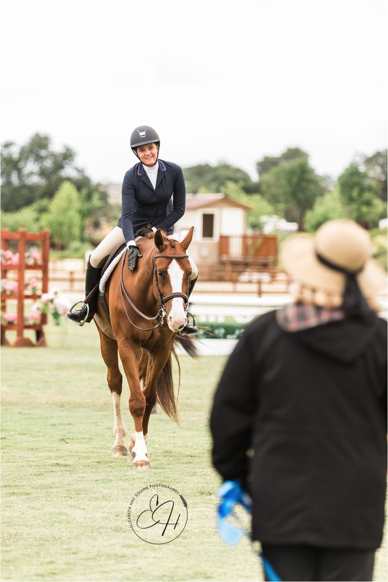 hunter rider accepting blue ribbon by Elizabeth Hay Photography