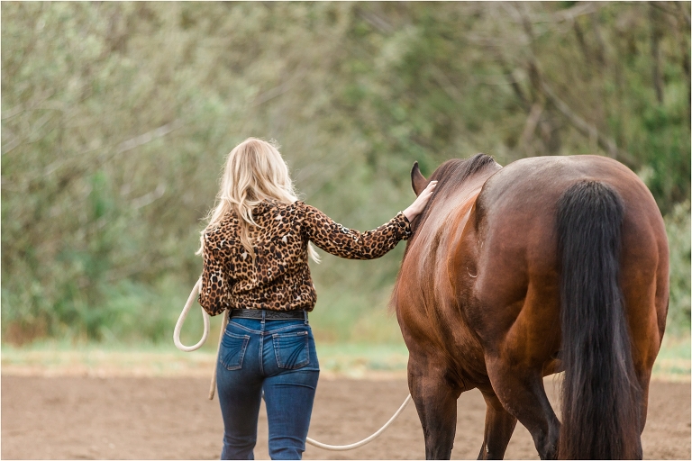 Blonde woman petting horse in Morro Bay Equine Photography session by Elizabeth Hay Photography
