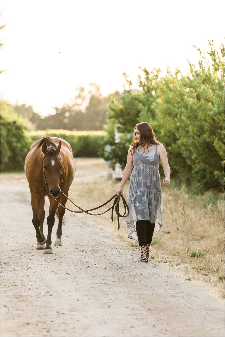 California Equine Photography Session of girl and her horse walking in an orchard by Elizabeth Hay Photography. 
