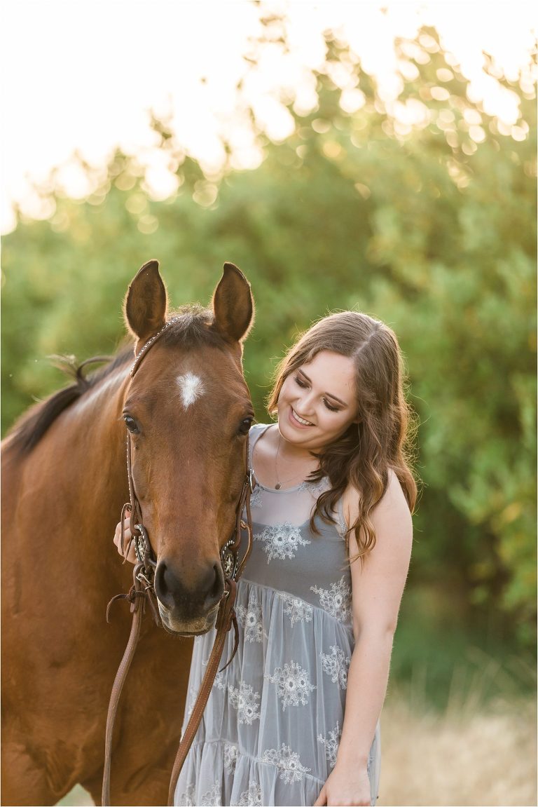 California Equine Photography Session of girl and her horse smiling in an orchard by Elizabeth Hay Photography. 