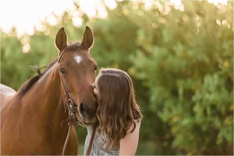 California Equine Photography Session of girl and her horse kissing in an orchard by Elizabeth Hay Photography. 