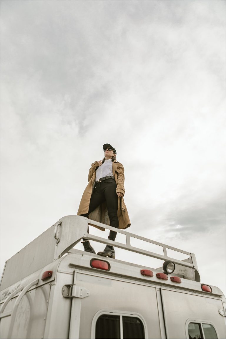 woman standing on top of horse trailer by California Equine Photographer Elizabeth Hay Photography.