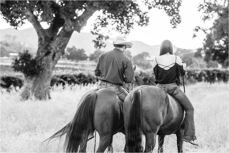 black and white image of cowboy and girl riding together by California Equine Photographer, Elizabeth Hay Photography.