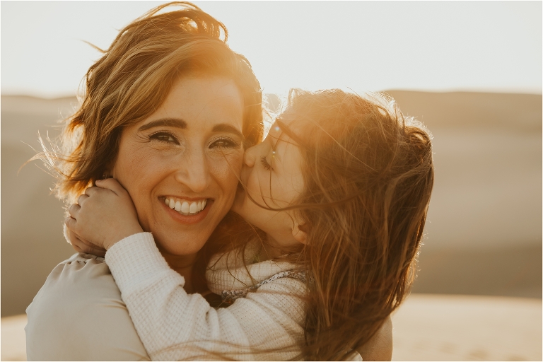 child kissing mother at the Pismo Beach Dunes by Elizabeth Hay Photography