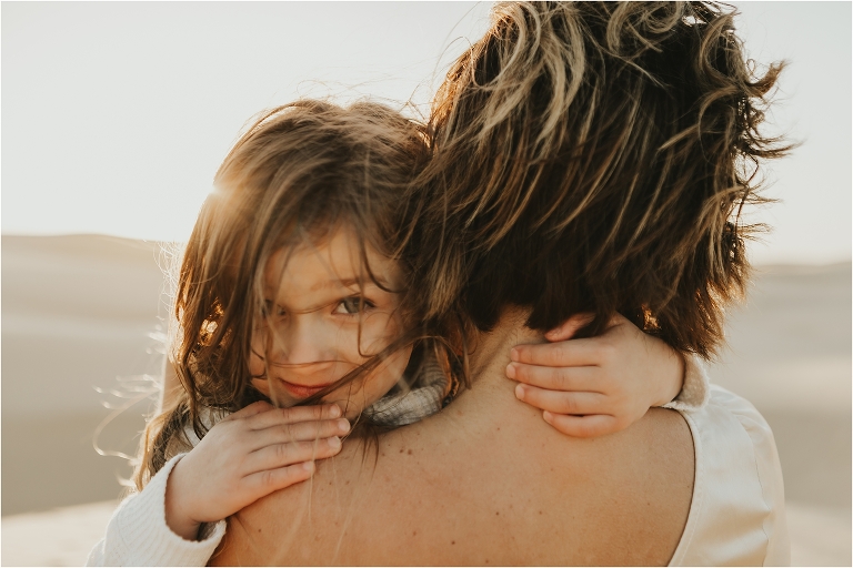 child and mother at Pismo dunes by Elizabeth Hay Photography