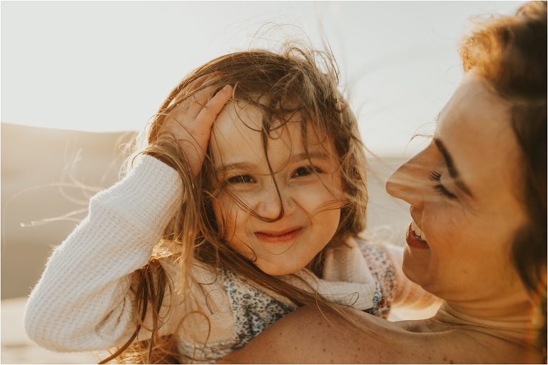 child and mother at Pismo dunes by Elizabeth Hay Photography