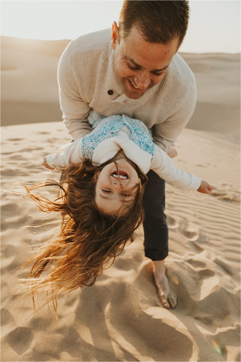 child and father at Pismo dunes by Elizabeth Hay Photography