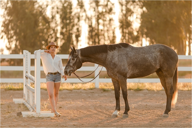 Taylor and her grey show jumper standing near horse jumps by California Equine Photographer, Elizabeth Hay Photography