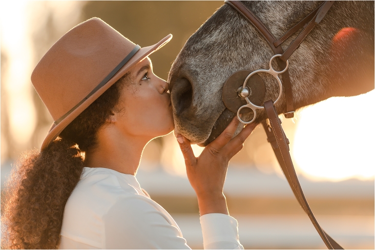 Taylor kissing her grey show jumper gelding by California Equine Photographer, Elizabeth Hay Photography