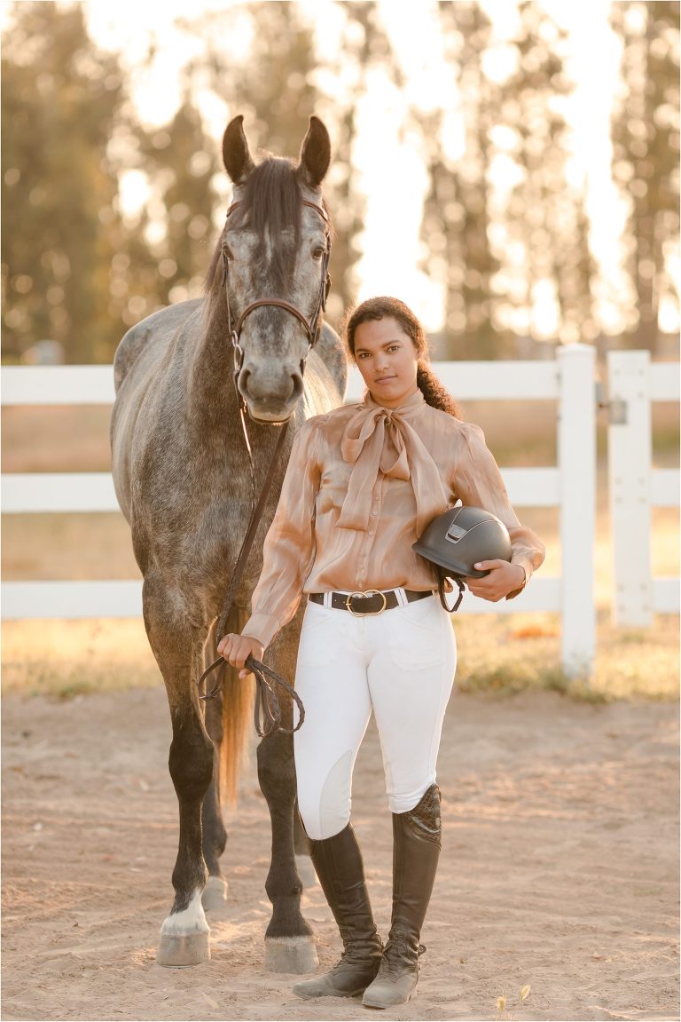 equestrian holding a Samshield helmut and grey show jumper gelding by California Equine Photographer, Elizabeth Hay Photography