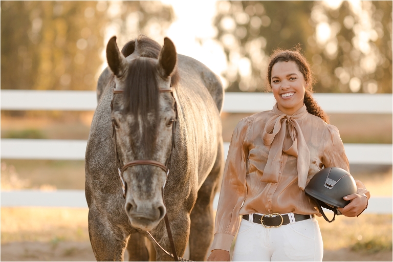 equestrian holding a Samshield helmut and grey show jumper gelding by California Equine Photographer, Elizabeth Hay Photography