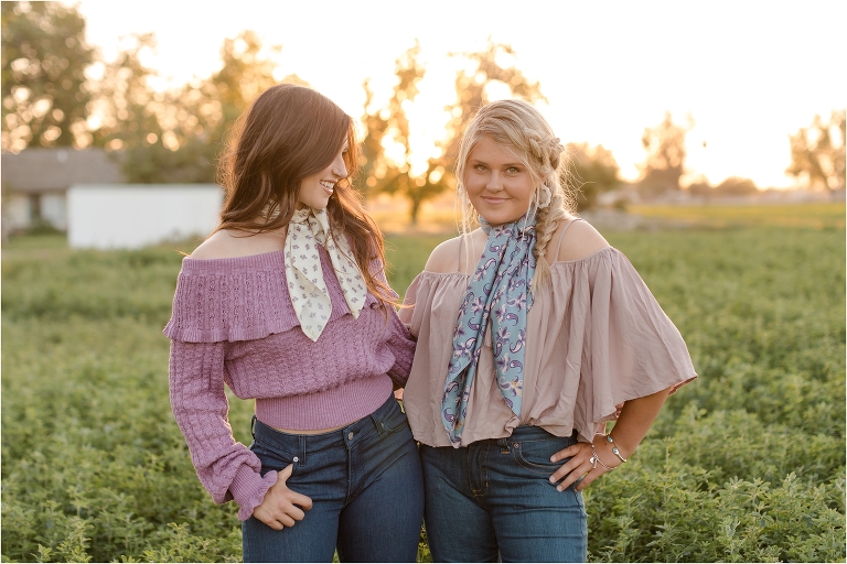 Two girls in an alfalfa field wearing wild rags as neck scarves