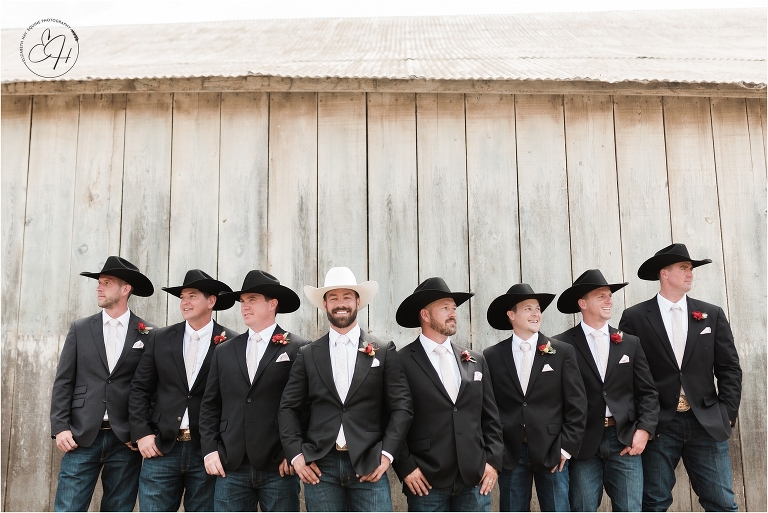 western groom and groomsmen against barn smiling prior to Morro Bay Ranch wedding