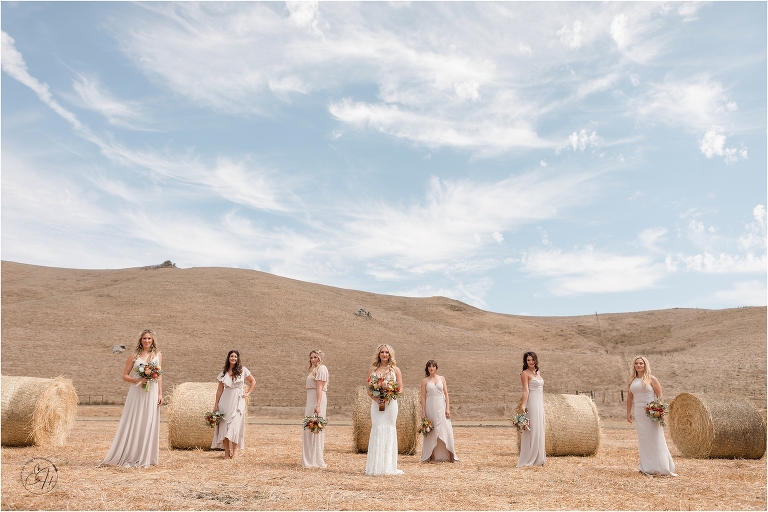 western bride and bridesmaids with round hay bales prior to Morro Bay Ranch wedding by Elizabeth Hay Photography