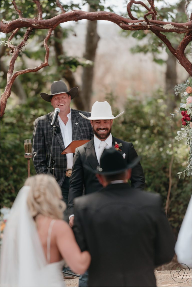 groom smiling as he sees his bride come down the aisle at Morro Bay Ranch wedding by Elizabeth Hay Photography