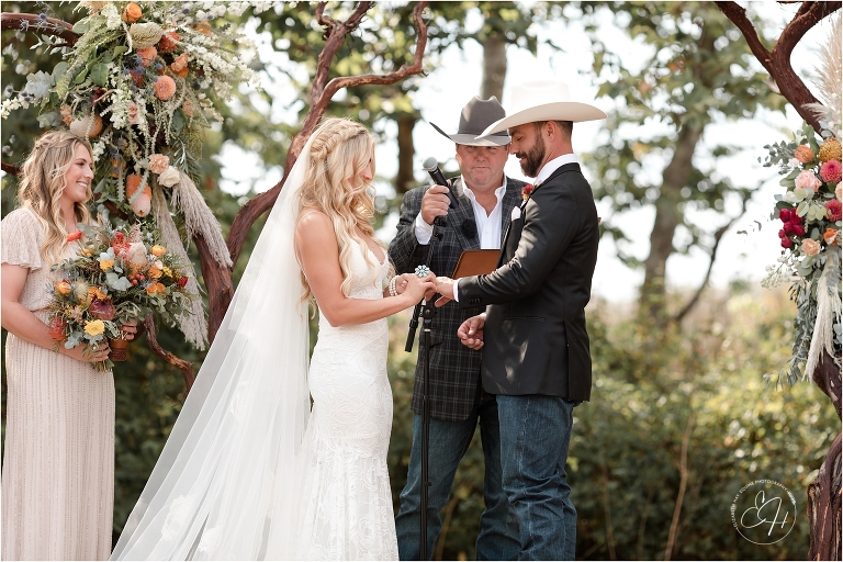 bride and groom exchanging rings at Morro Bay Ranch wedding by Elizabeth Hay Photography