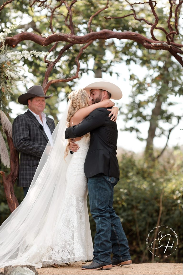 bride and groom kiss at western wedding by Elizabeth Hay Photography