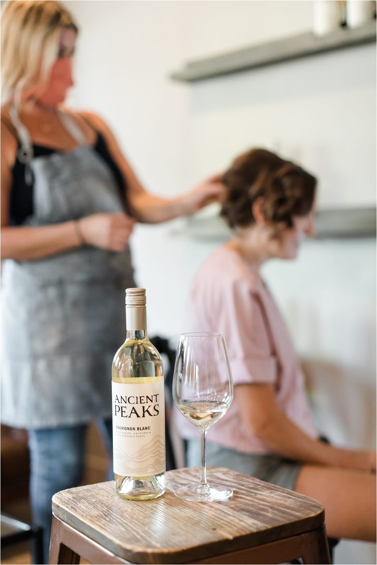 Ancient Peaks wine bottle while bride gets ready in the background for her Oyster Ridge Elopement wedding by Elizabeth Hay Photography