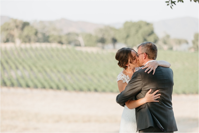 bride and groom first kiss at an Oyster Ridge Elopement wedding at a California Winery