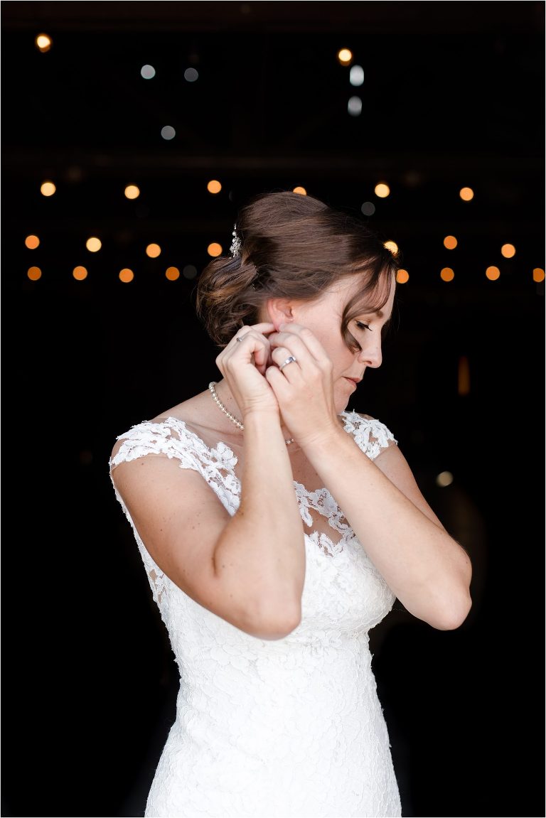 bride putting in her earrings before an Oyster Ridge Elopement wedding at a California Winery wedding