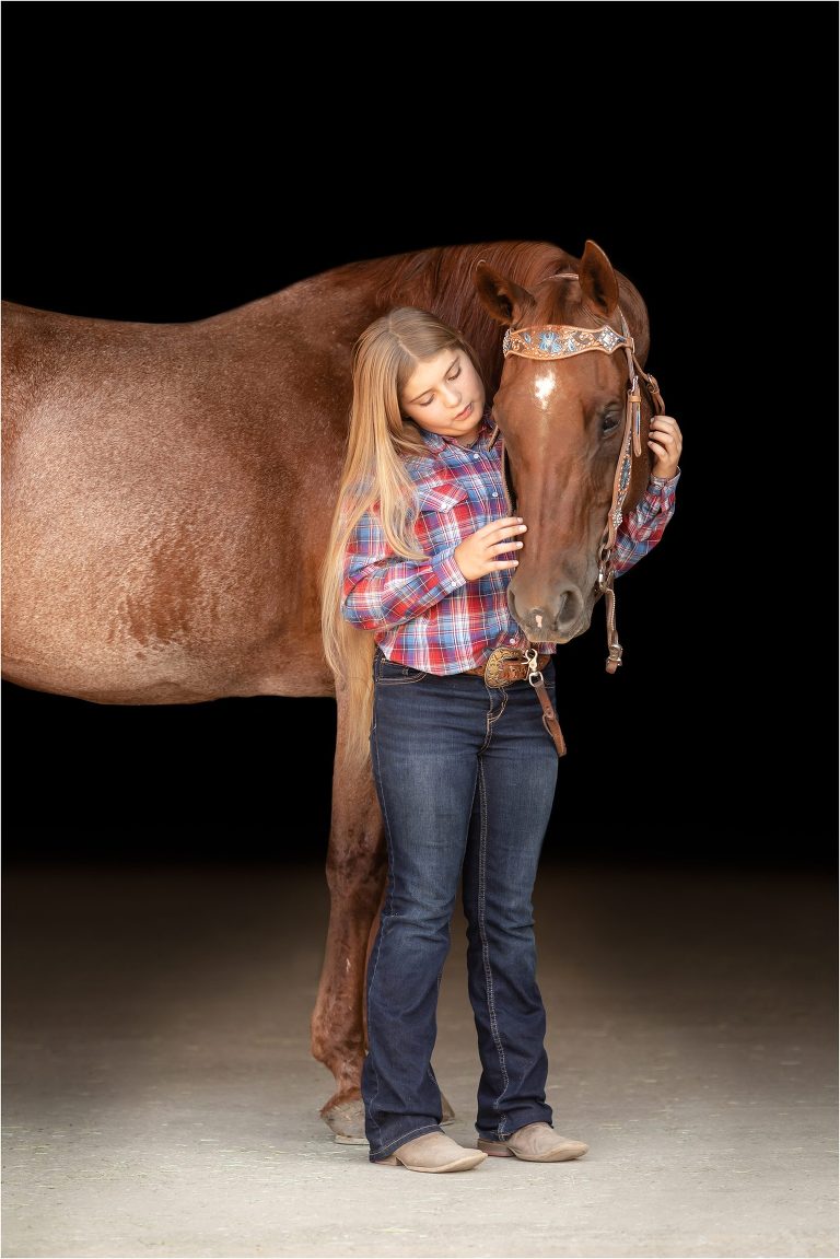 Western Black Background Portraits with American Quarter Horse Cowboy  being pet by little girl by Elizabeth Hay Photography