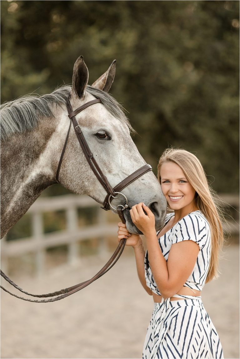 blonde girl resting her cheek on grey gelding by California Equine Photographer Elizabeth Hay Photography at Oak Park Equestrian Center. 
