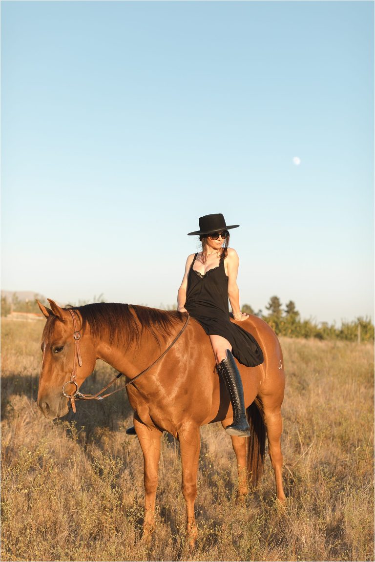 Milton Menasco x Celeris UK bespoke riding boot equestrian fashion shoot by California Equine Photographer Elizabeth Hay Photography with sorrel mare in golden field at sunset