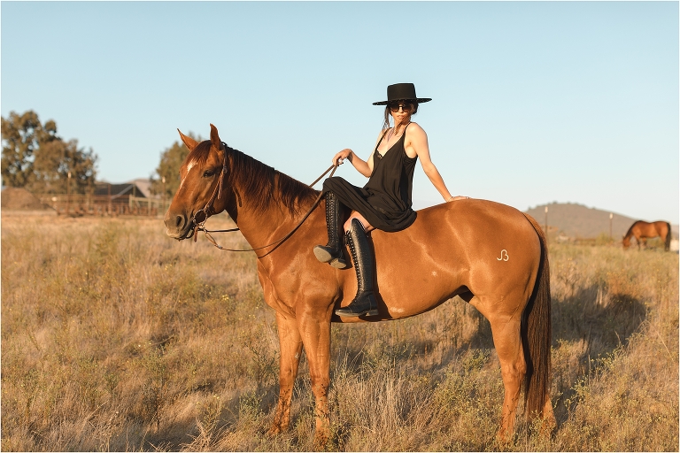 Milton Menasco x Celeris UK bespoke riding boot equestrian fashion shoot by California Equine Photographer Elizabeth Hay Photography with chestnut horse in golden field at sunset