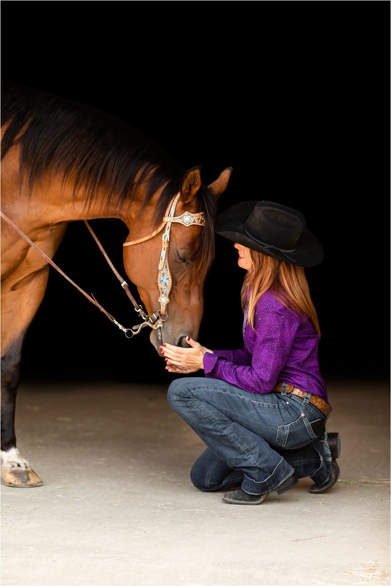 equine black background portrait of Bay gelding and woman by Elizabeth Hay Photography