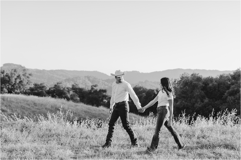 Paso Robles Engagement session at Epoch Estate Wines by Elizabeth Hay Photography with Becky and Mo walking hand in hand. 