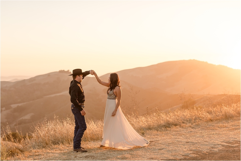 Western Engagement session on Highway 46 west by Elizabeth Hay Photography with Becky and Mo twirling