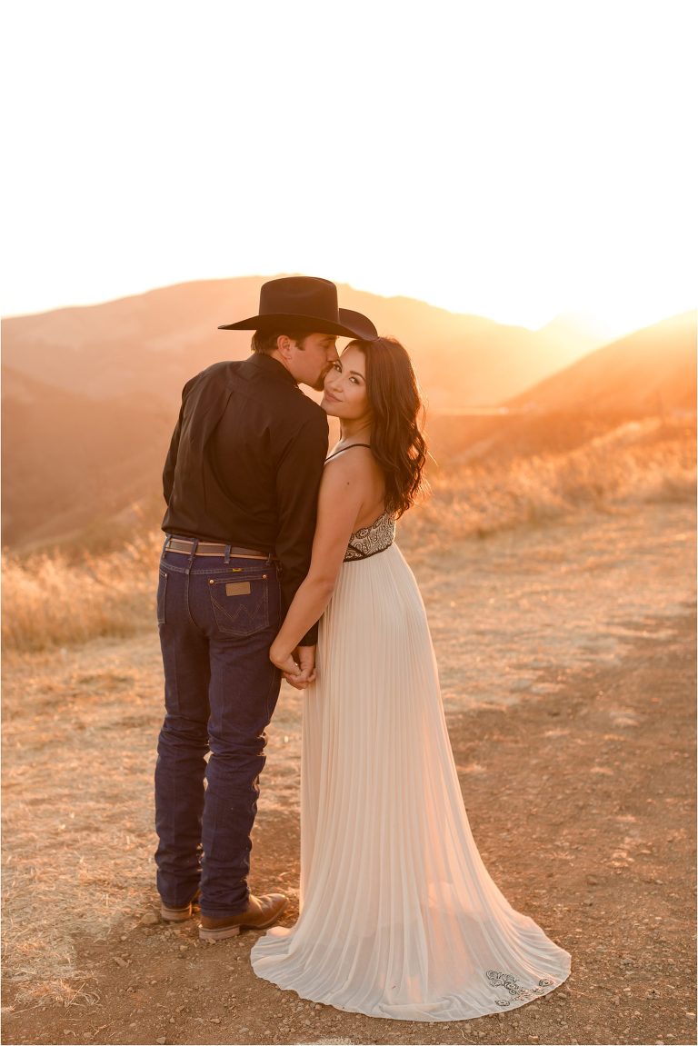 Western Engagement session on Highway 46 west by Elizabeth Hay Photography with Becky and Mo kissing.