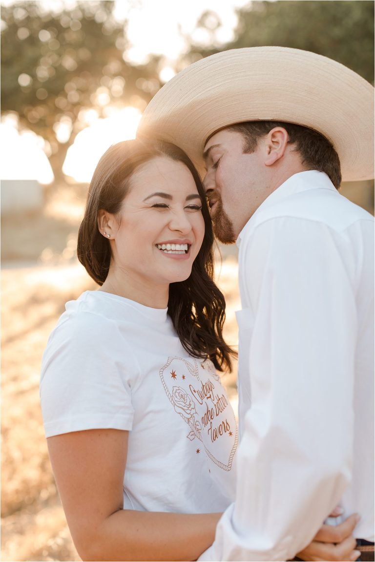 Paso Robles Engagement session at Epoch Estate Wines by Elizabeth Hay Photography with Becky wearing a short that reads "cowboys make better lovers"