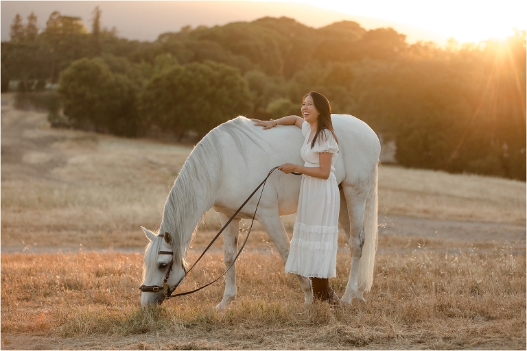 woman wearing white Ulla Johnson dress at sunset with Lusitano gelding by California Equine Photographer Elizabeth Hay Photography