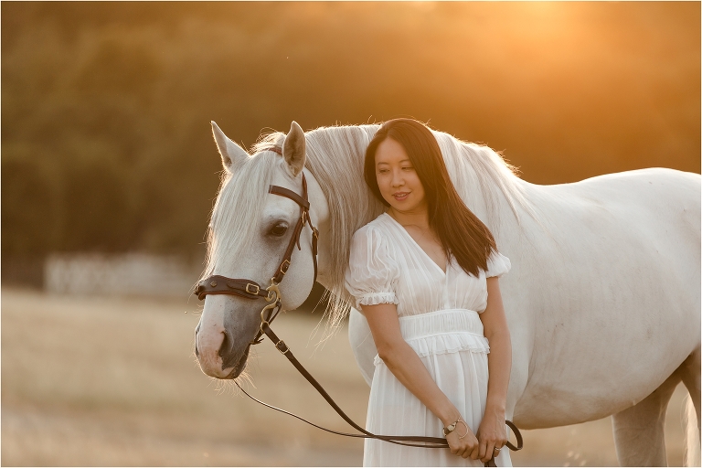 woman wearing flowy Ulla Johnson dress at sunset with Lusitano gelding by California Equine Photographer Elizabeth Hay Photography