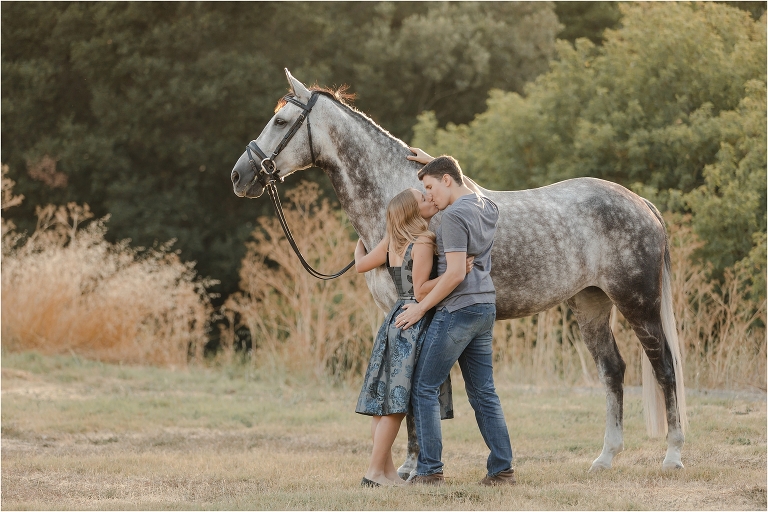 grey eventing horse and couple kissing at the Shiloh West Equestrian Center by California Equine Photographer Elizabeth Hay Photography